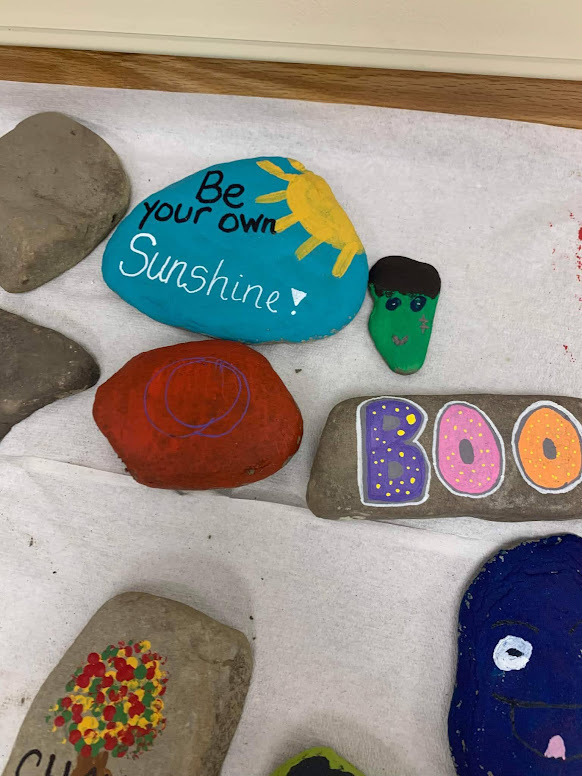 Rocks that students painted with inspirational messages.